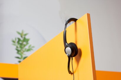 Headset hanging in a yellow shelf