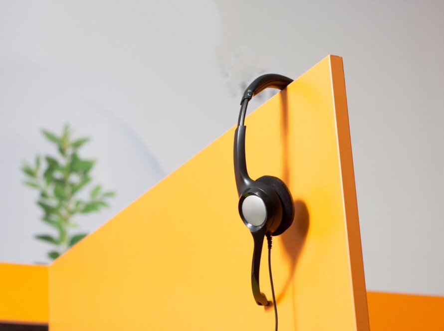 Headset hanging in a yellow shelf